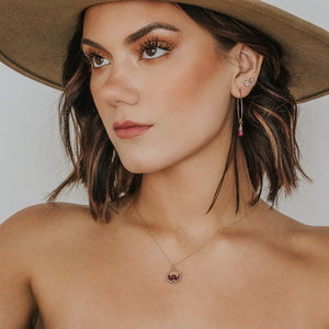 Custom healing ruby dew drop earrings from Justicia Jewelry on model