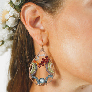 Custom healing Gaia Goddess earrings from Justicia Jewelry on model