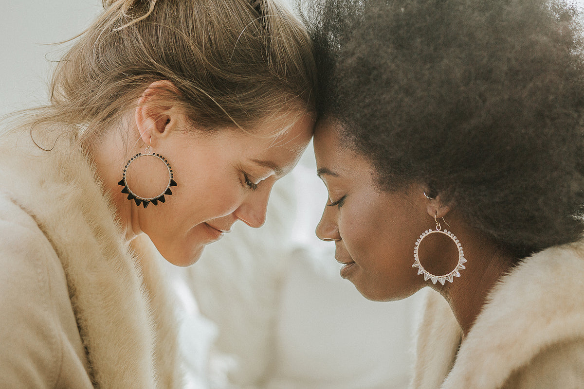 Beautiful women modeling Justicia Artisan Jewelry