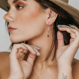 Custom healing aquamarine ruby dew drop earrings from Justicia Jewelry on model