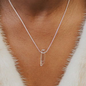 Custom healing clear quartz clarity necklace from Justicia Jewelry on model